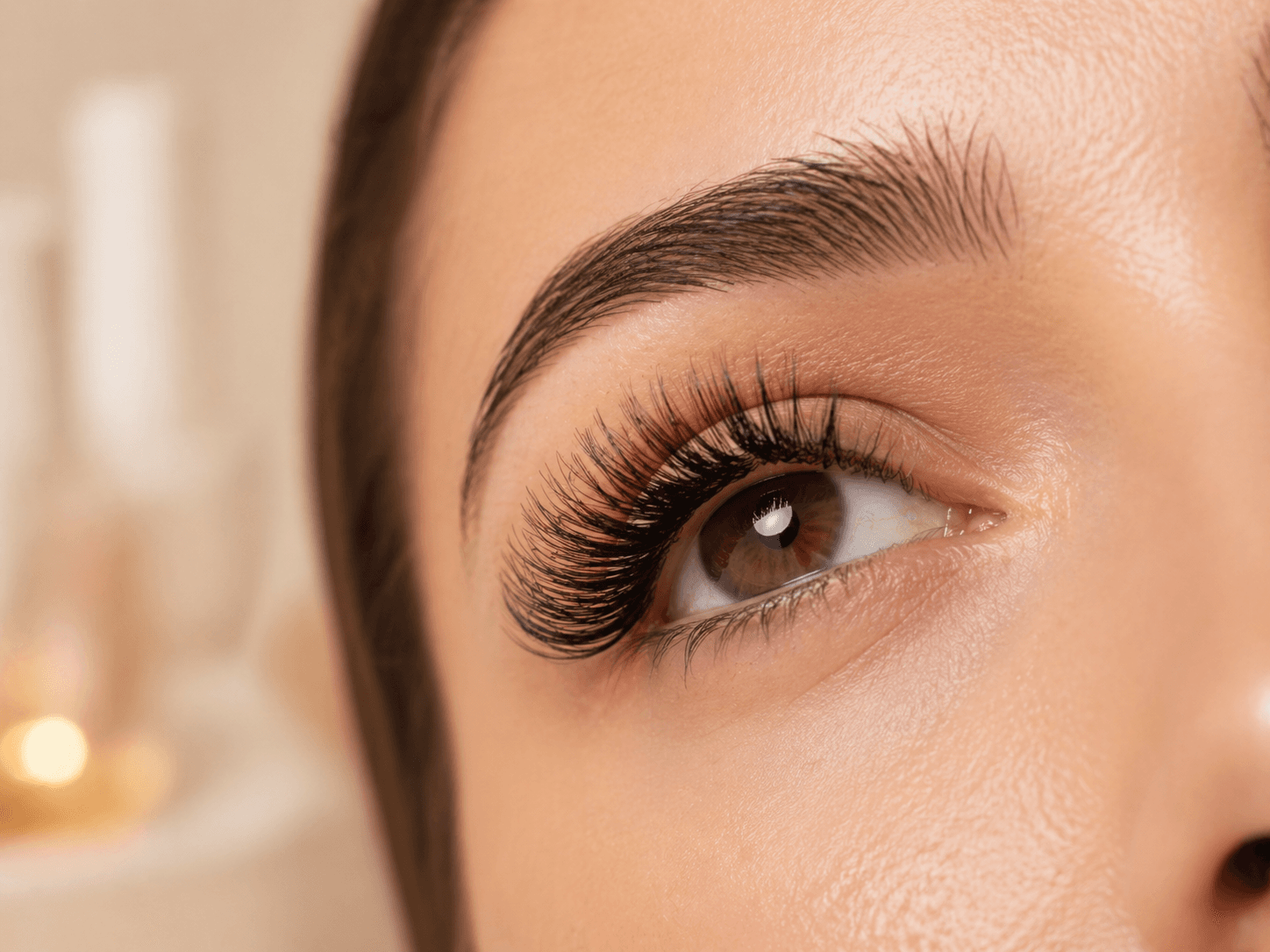 Close-up of polished brows and full lash extensions.