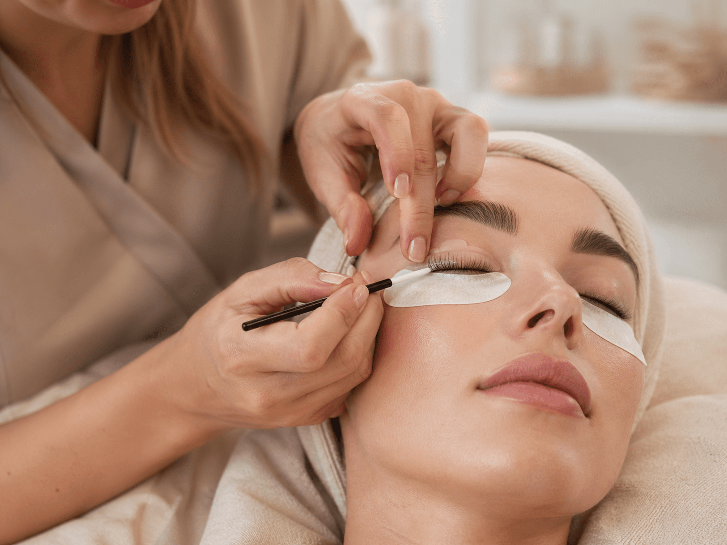 Lash lift and tint treatment being applied in a soft studio setting.